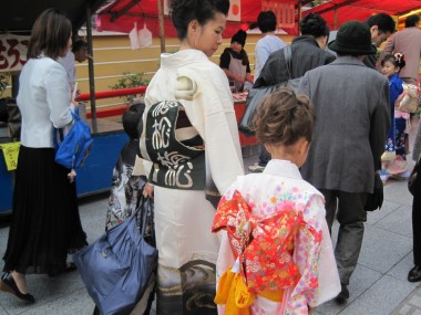 Shichi go san - Tomoko and Yuni in beautiful kimonos on the way to the temple for the ceremony for seven five and three year old children.