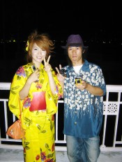 A woman in a yukata, light summertime version of the kimono, and a man with that style of shirt at a fireworks festival in Osaka.