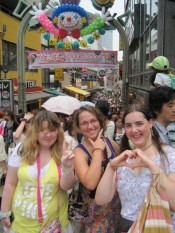 The girls posing for the photo in various Japanese ways in front of Takeshita Dori (street), in Harajuku, Tokyo, one of the fashion capitals of the world.